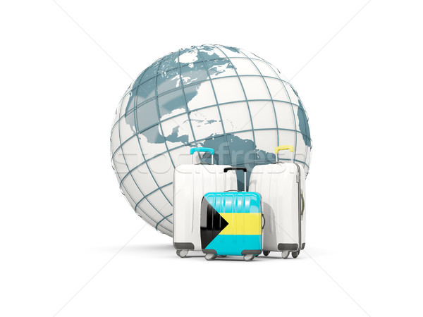 Luggage with flag of bahamas. Three bags in front of globe Stock photo © MikhailMishchenko