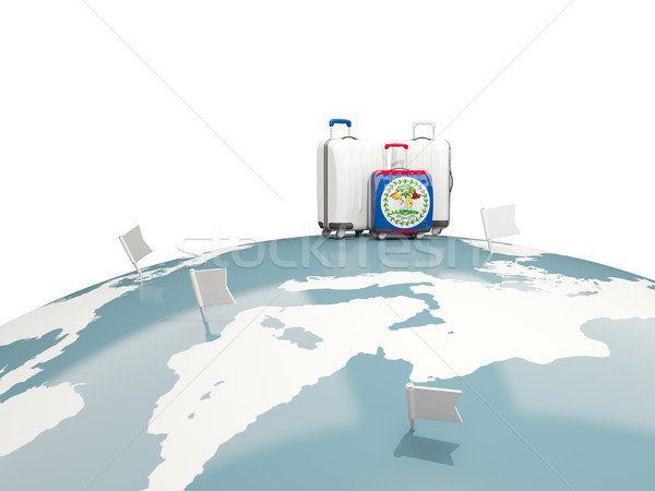 Luggage with flag of belize. Three bags on top of globe Stock photo © MikhailMishchenko