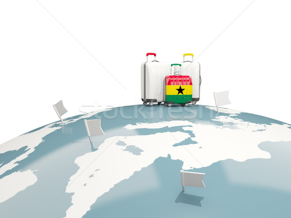 Luggage with flag of ghana. Three bags on top of globe Stock photo © MikhailMishchenko