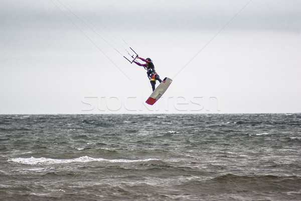 Kitesurfing. Athlete jumping out of the water Stock photo © MikhailMishchenko