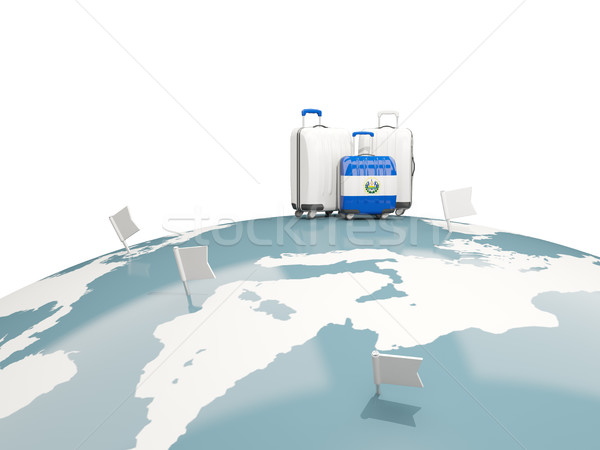 Luggage with flag of el salvador. Three bags on top of globe Stock photo © MikhailMishchenko