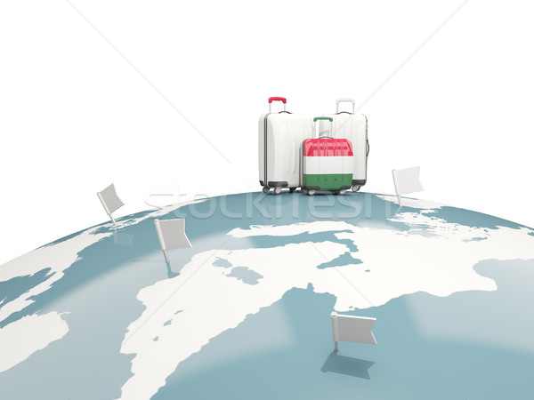 Luggage with flag of hungary. Three bags on top of globe Stock photo © MikhailMishchenko