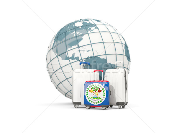 Luggage with flag of belize. Three bags in front of globe Stock photo © MikhailMishchenko