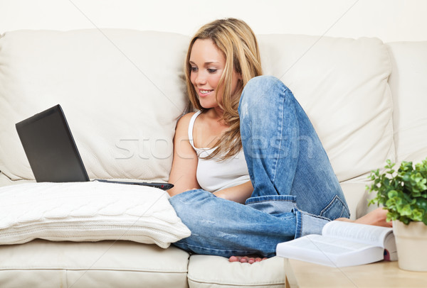 Dość młoda kobieta laptop uśmiechnięty posiedzenia biały Zdjęcia stock © MikLav