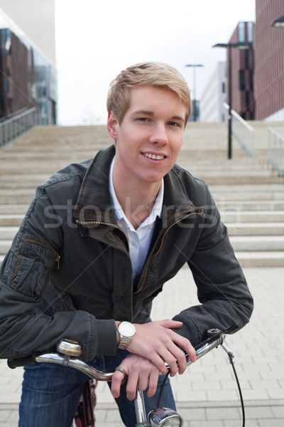 Stock photo: Young man with bicycle