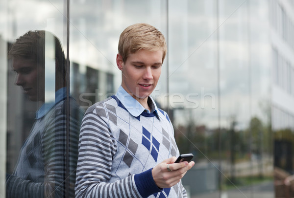 Moço jovem homem bonito celular em pé Foto stock © MikLav