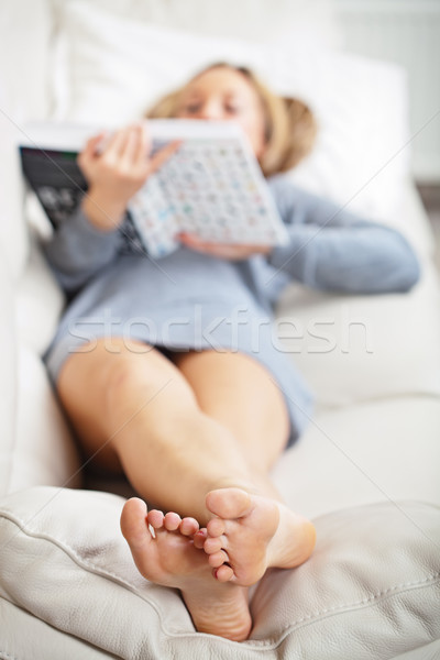 Woman lying on sofa with book Stock photo © MikLav