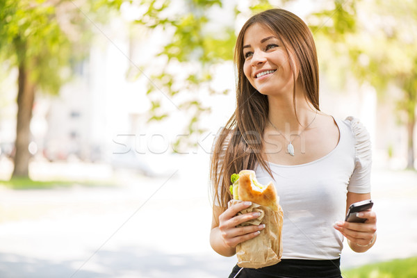 Stock photo: Young Woman taking a break for breakfast