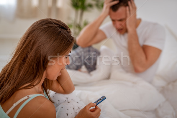 Nieszczęśliwy kobieta test ciążowy młoda kobieta posiedzenia bed Zdjęcia stock © MilanMarkovic78