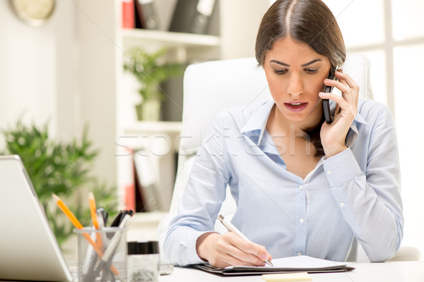 Businesswoman Phoning In The Office Stock photo © MilanMarkovic78