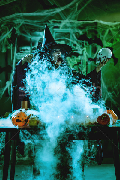 Witch Tells Magic Words To Skull Stock photo © MilanMarkovic78