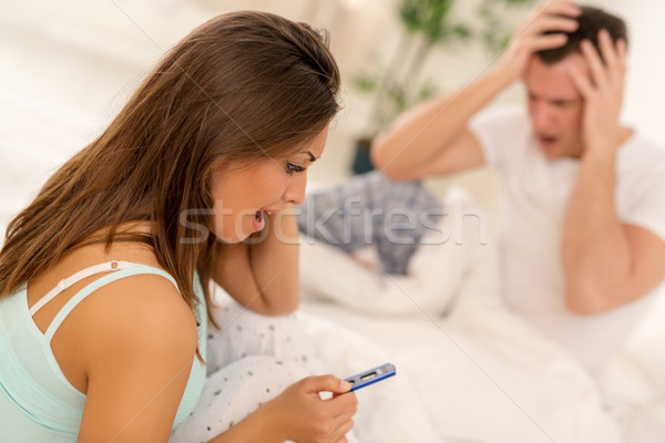 Nieszczęśliwy kobieta test ciążowy młoda kobieta posiedzenia bed Zdjęcia stock © MilanMarkovic78