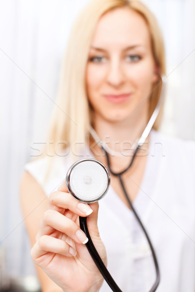 Female doctor holding stethoscope Stock photo © MilanMarkovic78