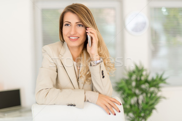 Businesswoman Phoning In Office Stock photo © MilanMarkovic78