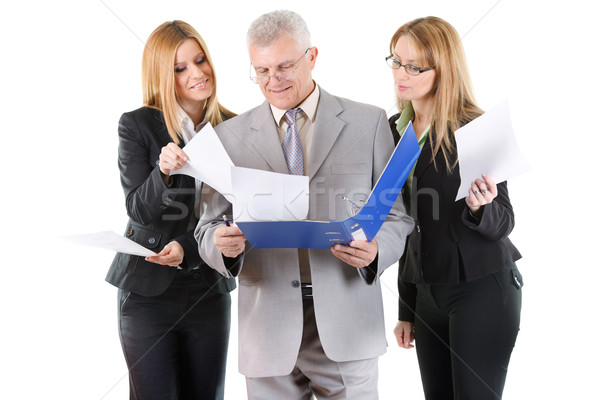 Three smiling business people looking at documents Stock photo © MilanMarkovic78