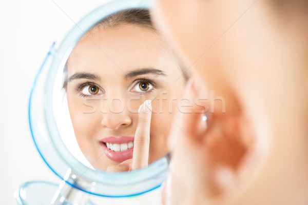 Teenage Girl Putting Cream On Her Face Stock photo © MilanMarkovic78