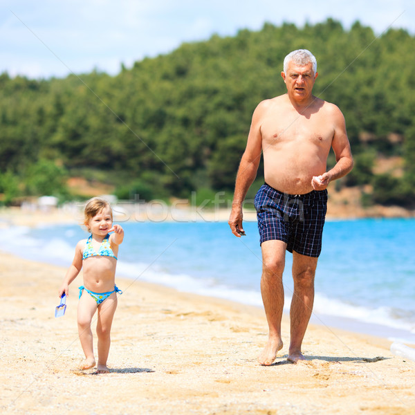 Stock photo: Senior Man With Granddaughter On The Beach