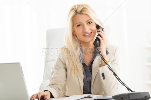 Blonde Businesswoman Phoning In The Office Stock photo © MilanMarkovic78