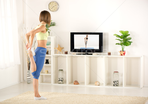 Nő testmozgás tv fiatal nő sportok ruházat Stock fotó © MilanMarkovic78