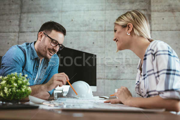 Stock photo: Young Architects Analyzing Blueprints