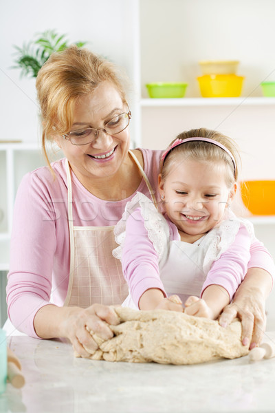 Happy Little Girl with grandmother in the kitchen Stock photo © MilanMarkovic78
