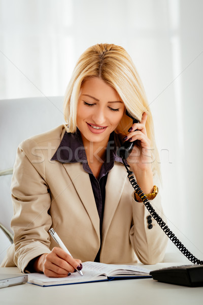 Businesswoman Phoning In The Office Stock photo © MilanMarkovic78
