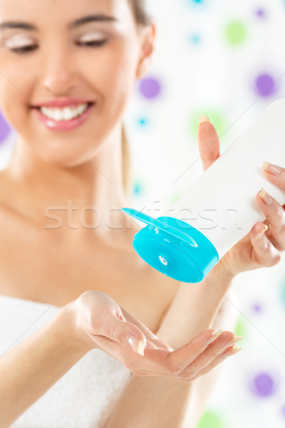 Stock photo: Girl With A Tube Of Body Lotion