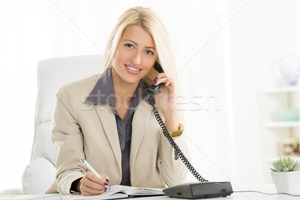 Businesswoman Phoning In The Office Stock photo © MilanMarkovic78