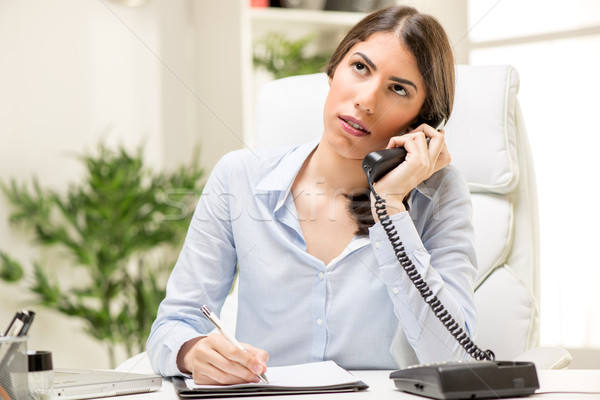 Businesswoman Phoning In The Office Stock photo © MilanMarkovic78