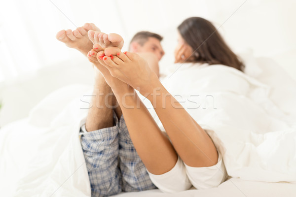 Lusta reggel lábak fiatal heteroszexuális pár megnyugtató Stock fotó © MilanMarkovic78