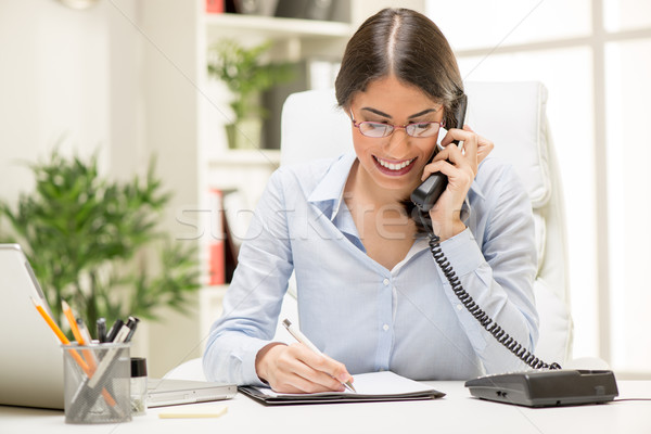 Businesswoman Phoning In The Office Stock photo © MilanMarkovic78