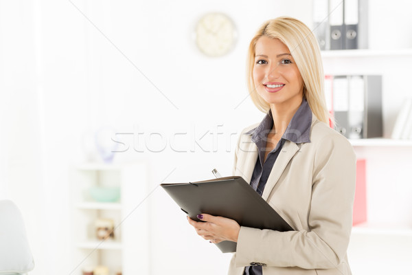 Blonde Businesswoman With Folder Stock photo © MilanMarkovic78