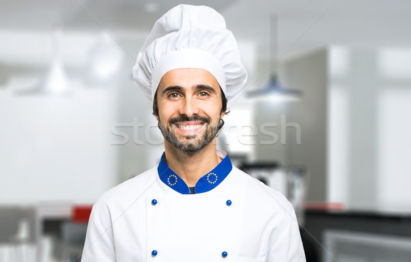 Smiling chef in his kitchen Stock photo © Minervastock