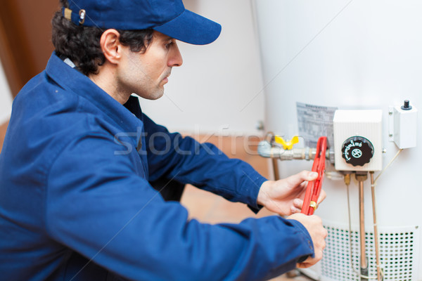 Plumber fixing an hot-water heater Stock photo © Minervastock