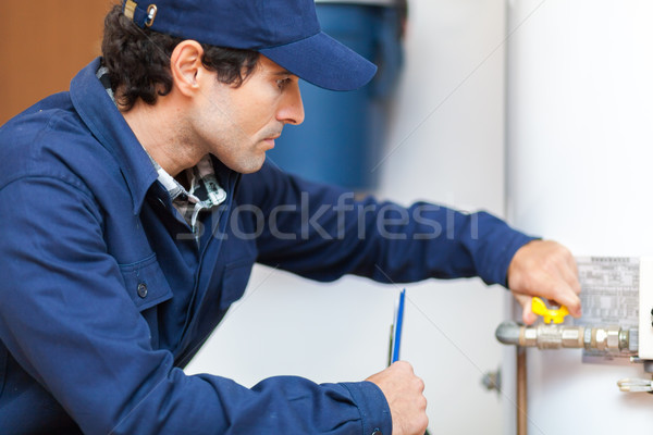 Plumber repairing an hot-water heater Stock photo © Minervastock