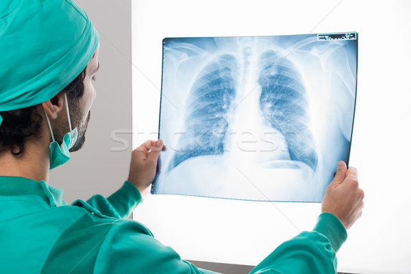Surgeon analyzing a lung radiography Stock photo © Minervastock