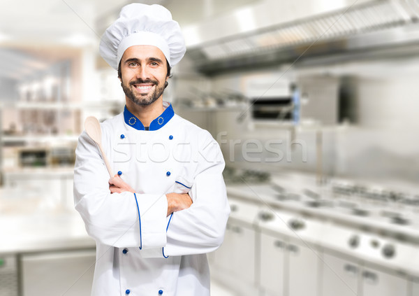 Smiling chef in his kitchen Stock photo © Minervastock