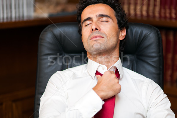 Businessman loosing his necktie after an hard working day Stock photo © Minervastock