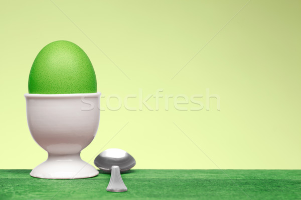 green egg in white egg cup Stock photo © MiroNovak