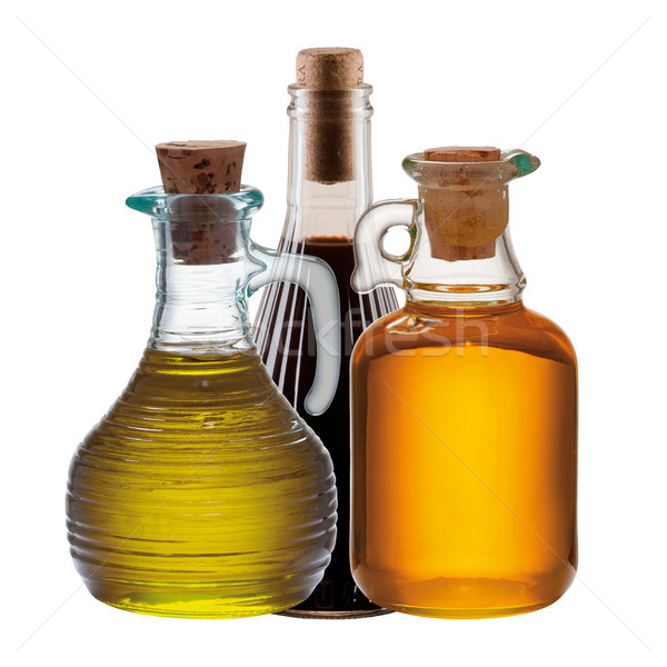 Três garrafas azeite vinagre isolado branco Foto stock © MiroNovak