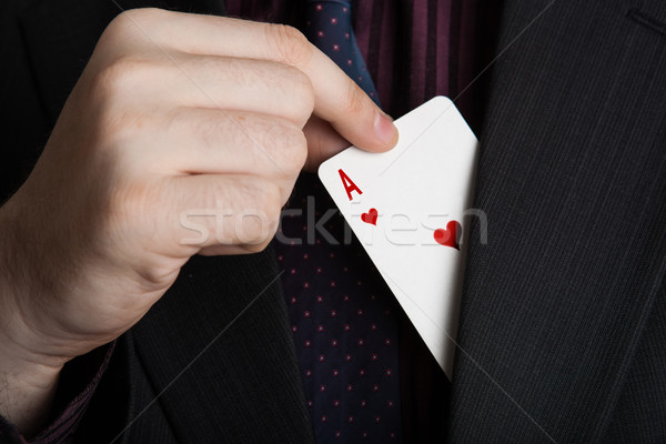 Stock photo: hand pulls the card ace of hearts