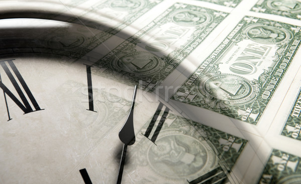 clock on the background of banknotes dollars Stock photo © mizar_21984
