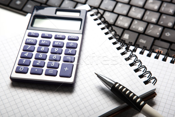 pen with calculator on a notebook and keyboard Stock photo © mizar_21984
