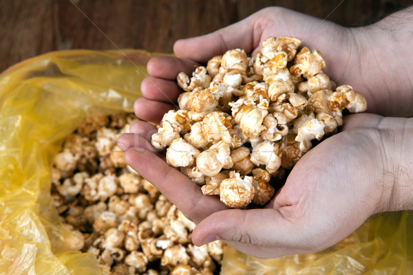 people gaining a bunch of popcorn from the package  Stock photo © mizar_21984