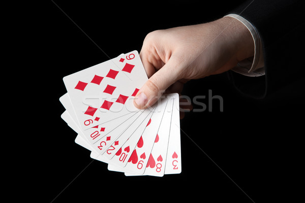 male hand holding a fan of playing cards Stock photo © mizar_21984