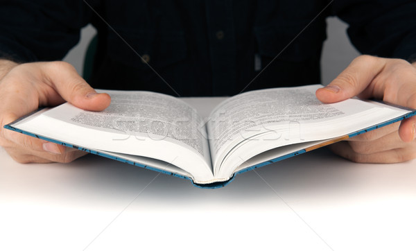 Man's hands and man looking for something in the book Stock photo © mizar_21984