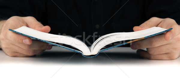 Man's hands and man looking for something in the book Stock photo © mizar_21984