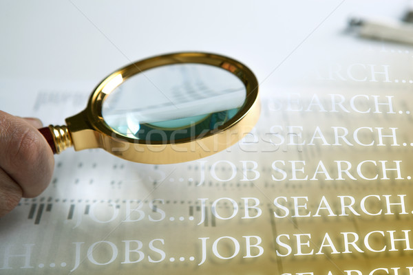 inscription job search and a hand holding a magnifying glass Stock photo © mizar_21984