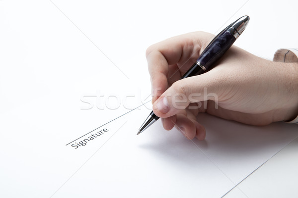 pen in the man's hand and signature Stock photo © mizar_21984