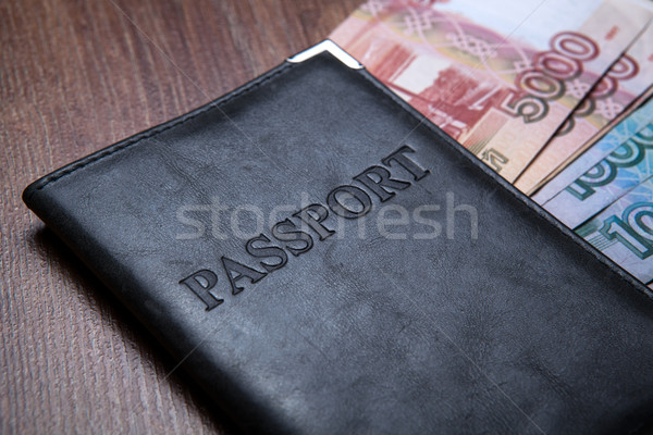 Passport on a table with paper money Stock photo © mizar_21984